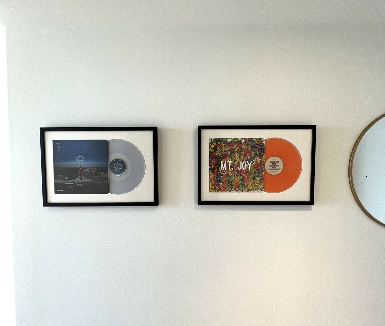 Framed vinyl records from Level Frames on an accent wall