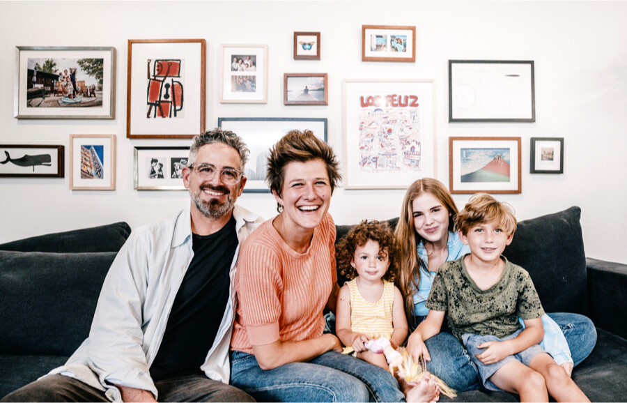 Eclectic gallery wall for family room with framed art and photos