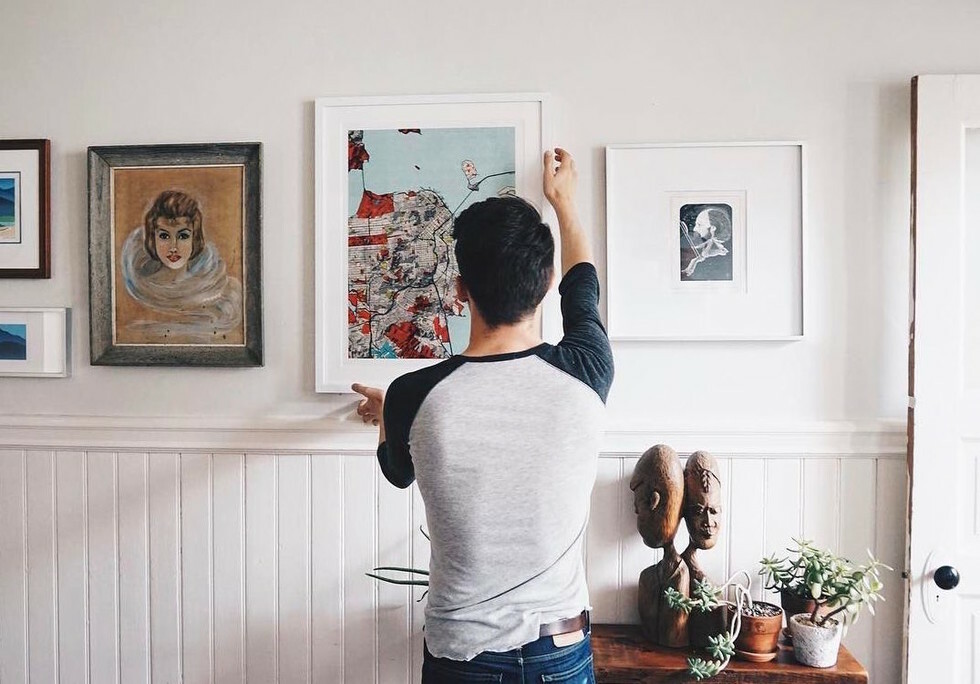 Hanging framed art and photos at eye level
